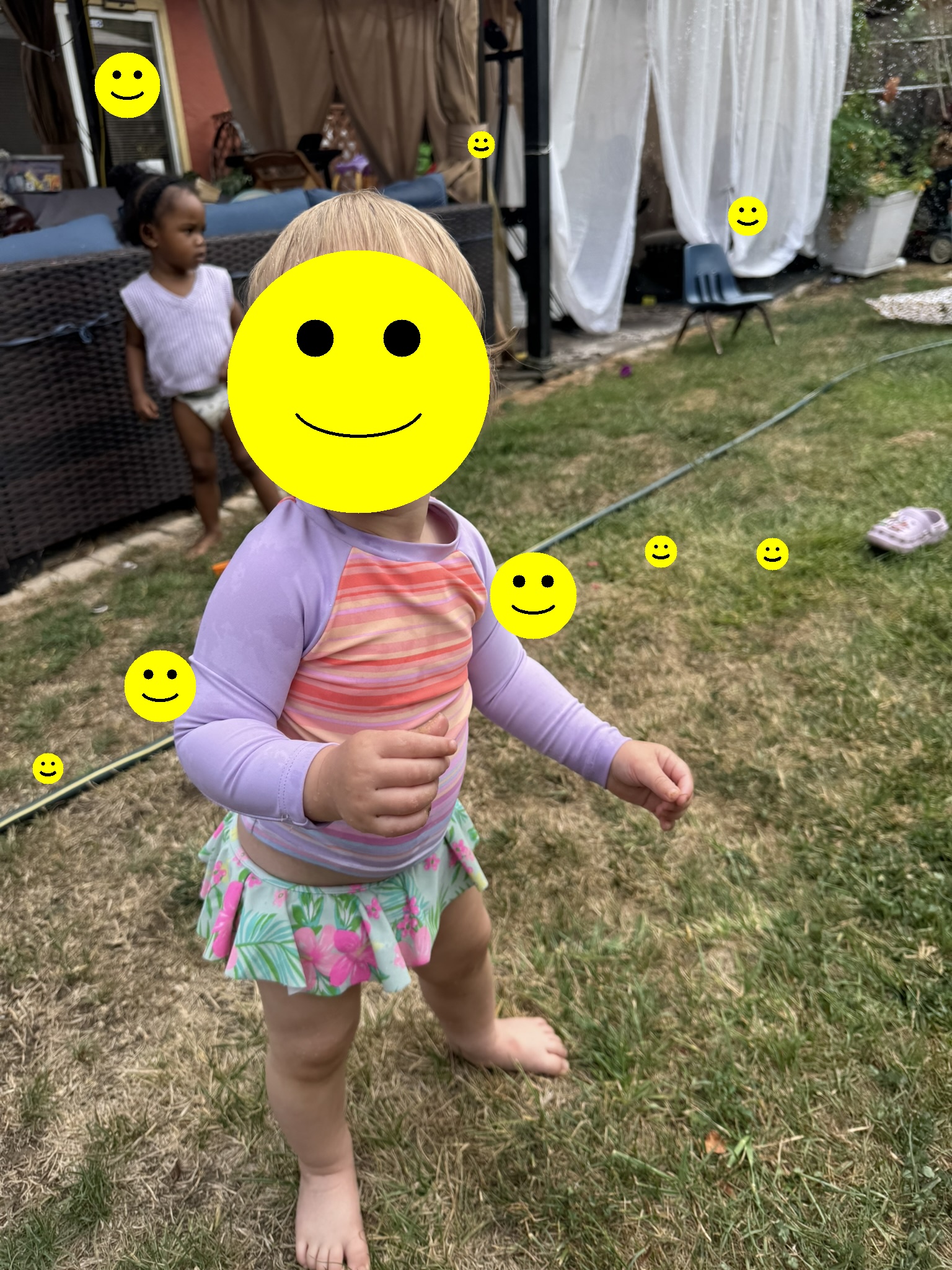 Children playing freely on the backyard lawn